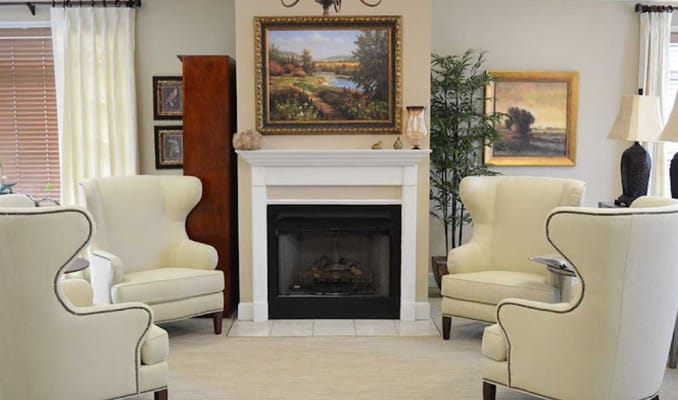 Cozy interior common area with elegant armchairs and fireplace