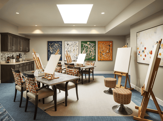 Art studio setup with easels and colorful paintings