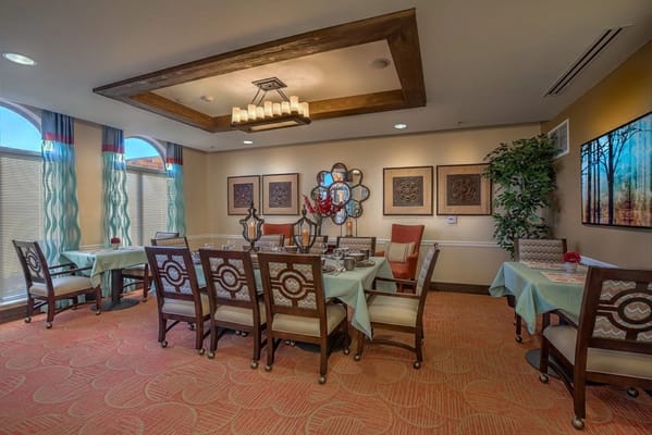 Bright common area with dining tables and artwork