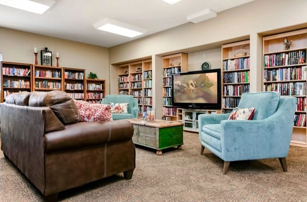 Common area with comfortable seating and bookshelves