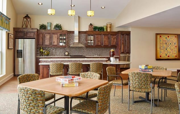 Bright common area with kitchen and dining tables