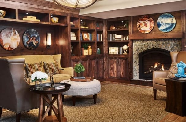 Cozy common area with fireplace and bookshelves