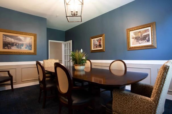 Elegant common area with dining table and artwork