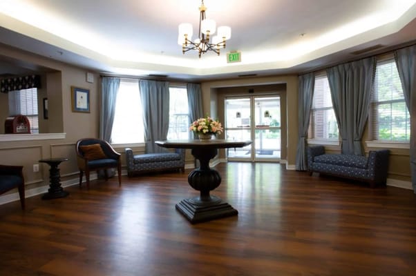 Bright common area with seating and floral centerpiece