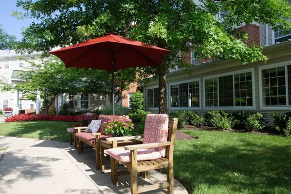 Outdoor seating area with an umbrella and flowers