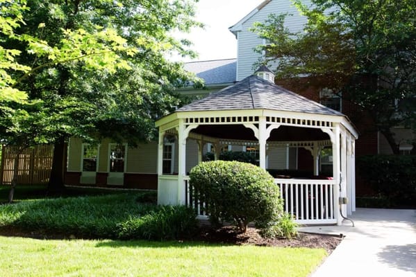 Outdoor gazebo surrounded by greenery