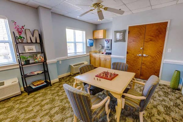 Bright common area with a chess table and seating