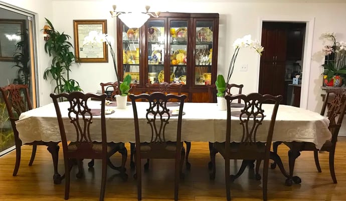 Elegant dining room with a long table and wooden chairs