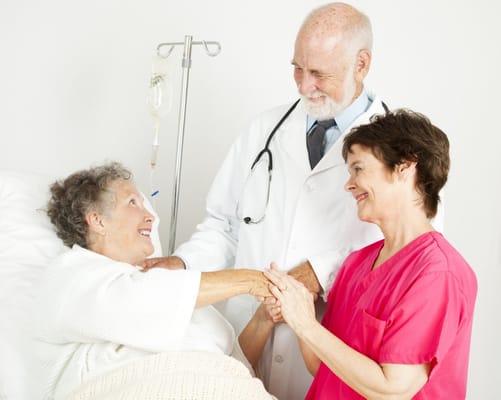 Healthcare staff interacting with a resident in a room
