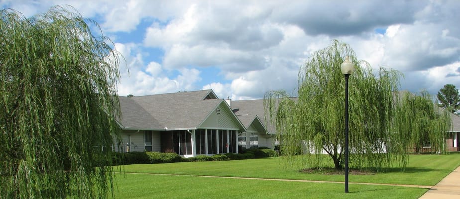 Exterior view of the facility with landscaping and trees