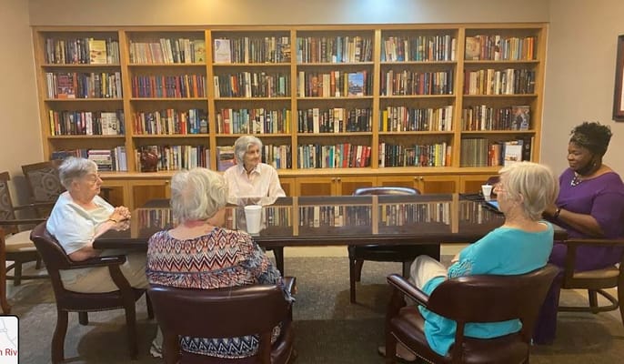 Residents engaging in a discussion in the activity room