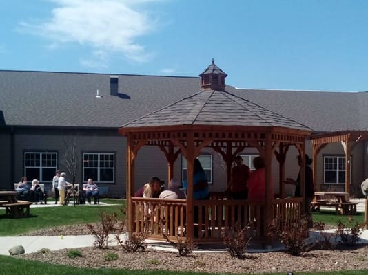 Residents enjoying time in a gazebo at an outdoor space