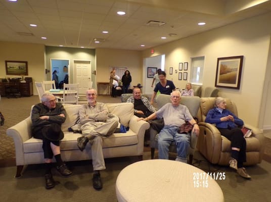 Residents relaxing in a common area with comfortable seating