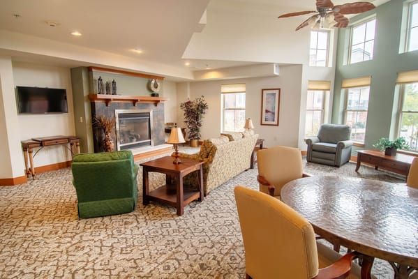 Bright common area with comfortable seating and a fireplace