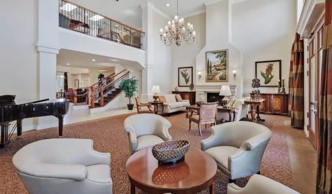 Bright and welcoming common area with seating and piano