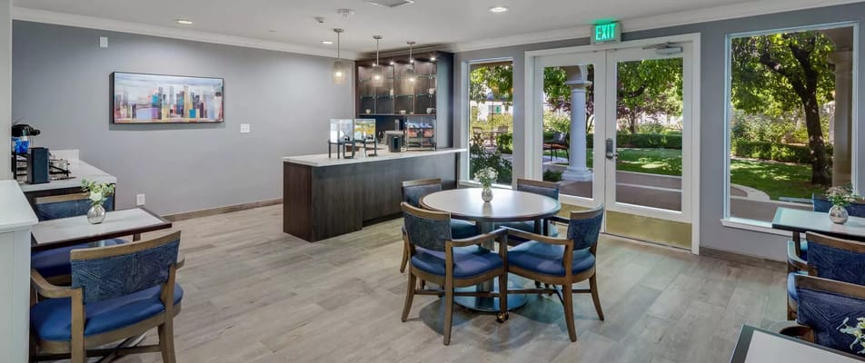 Bright common area with seating and outdoor view