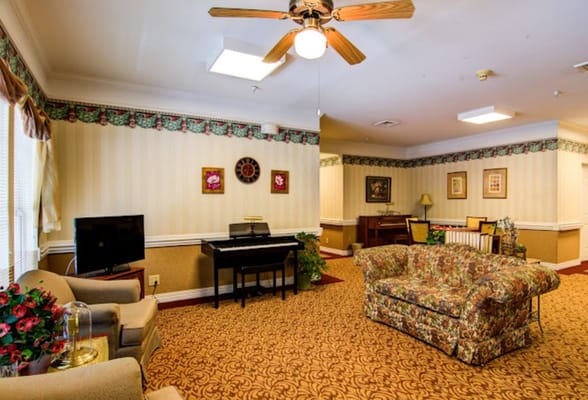 Cozy common area with floral couch and piano