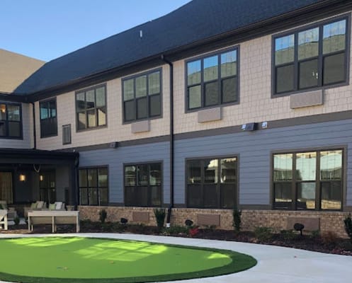 Exterior view of a senior living facility with green space