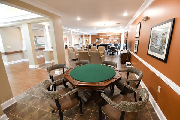 Interior view of a common area with seating and a game table
