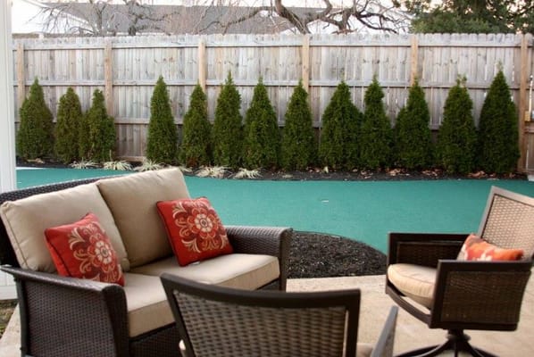 Outdoor seating area with landscaped backdrop