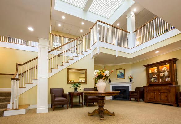 Spacious lobby with staircase and seating area