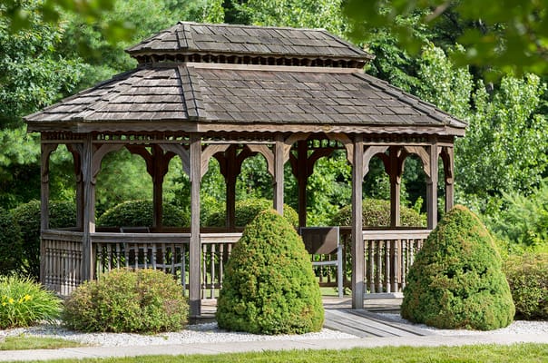 Wooden gazebo surrounded by greenery