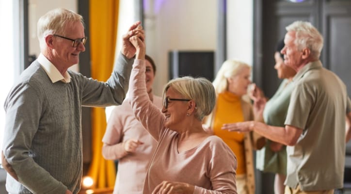 Seniors dancing together in a social setting