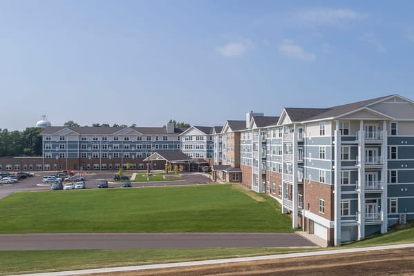 Aerial view of Overlook Village senior living facility showing multiple buildings and green lawn.