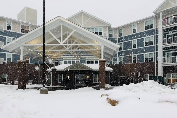 Snow-covered entrance of Overlook Village senior living facility