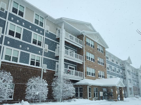 Snow-covered exterior of Overlook Village senior living facility