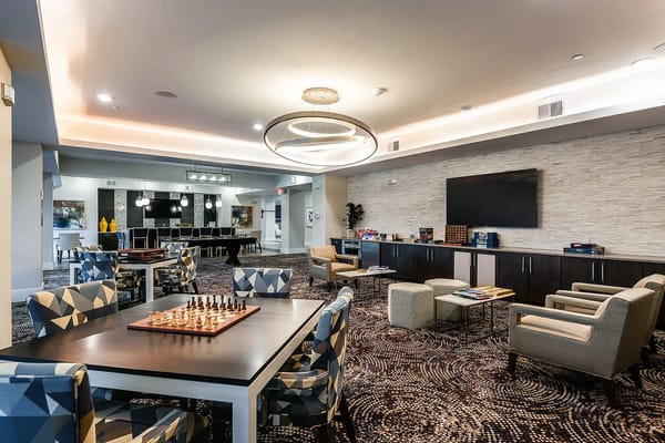 Interior view of a common area with chess table and seating