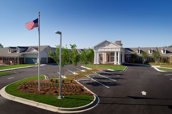 Exterior view of the facility with landscaping and flag