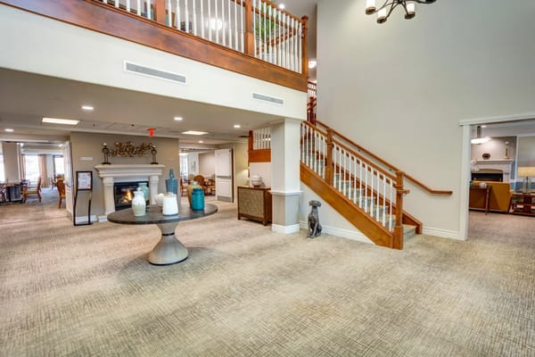 Spacious lobby at Palmilla Senior Living with stairs and a decorative table