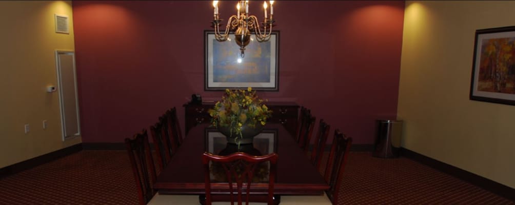 Elegant dining room with a long table and chandelier