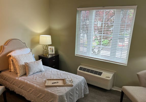 Cozy resident room with natural light and neat decor