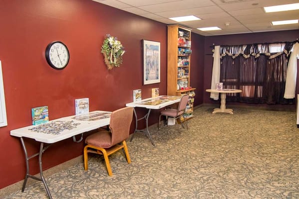 Quiet common area with tables and puzzles