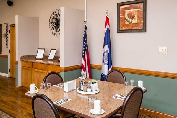 Dining table set for a meal in a common area