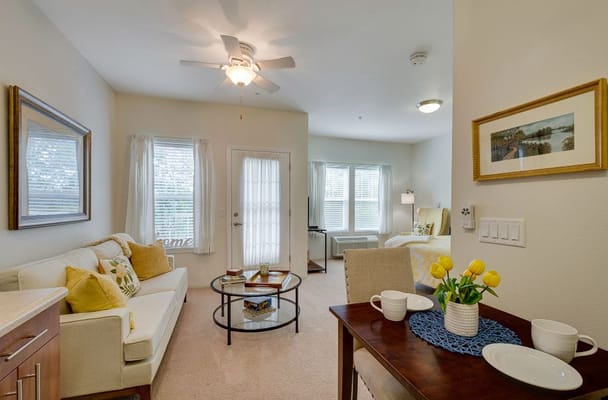 Cozy resident room with seating area and dining setup