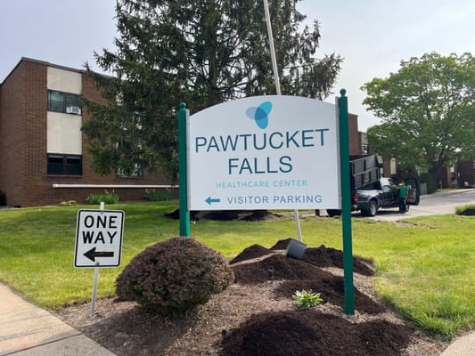 Sign displaying facility name and parking information