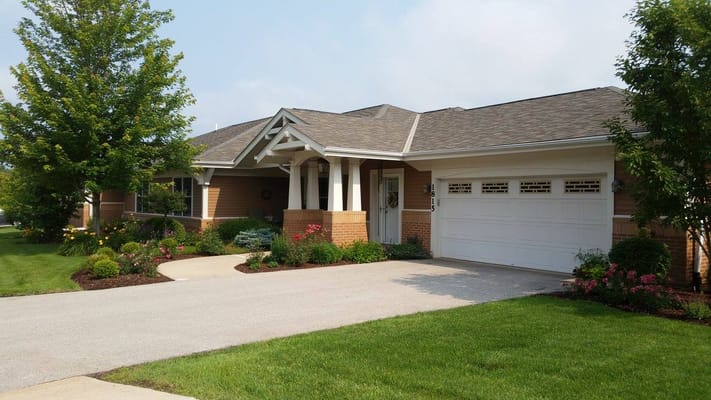 Exterior view of a senior living facility with landscaped gardens