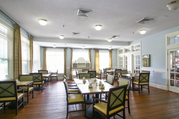 Dining room with tables and chairs arranged for meals