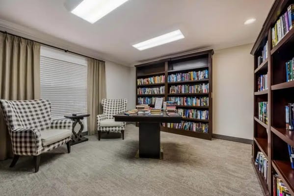 Comfortable reading area with bookshelves and armchairs