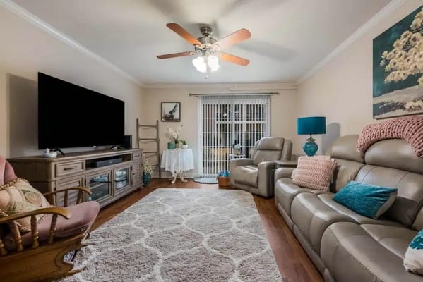 Comfortable living room featuring plush seating and a large TV