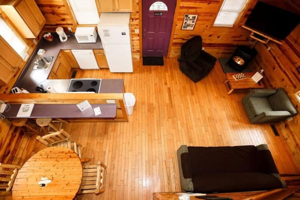 Aerial view of a cozy common area with a kitchen and seating.