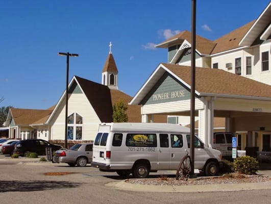Exterior view of Pioneer House with facility van