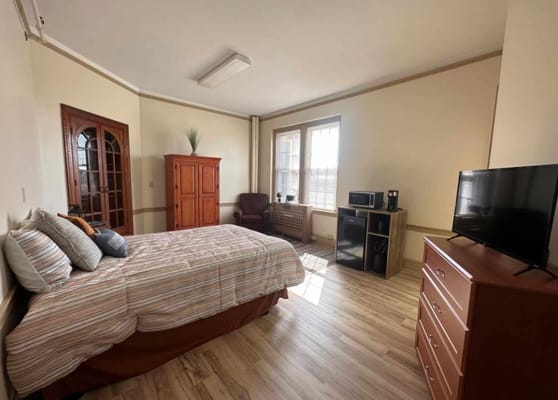 Bright interior of a private resident room with furniture