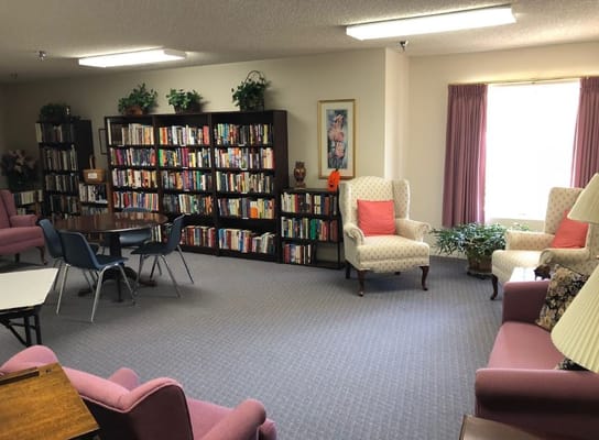 Cozy lounge area with bookshelves and seating