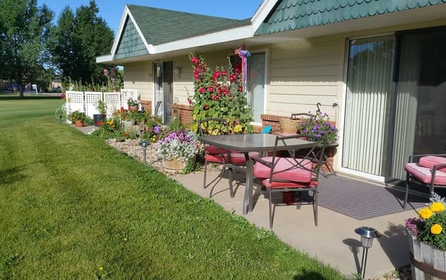Outdoor patio with garden flowers at Regency Retirement Residence