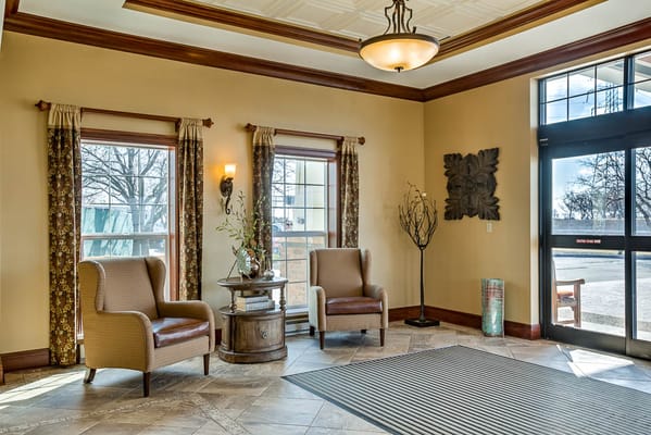 Inviting lobby area with two chairs and large windows