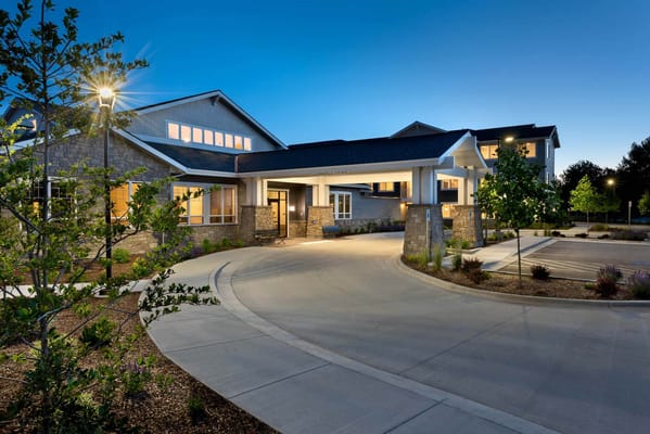 Front entrance of a senior living facility at dusk